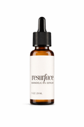 Skincare serum bottle labeled 'resurface' on a white background